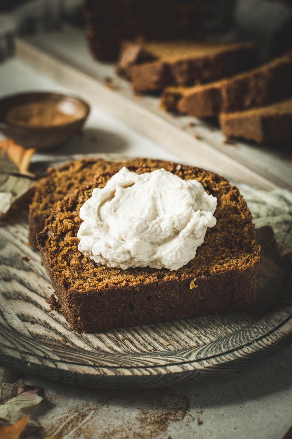 https://www.aimeemars.com/wp-content/uploads/2019/09/Moist-Pumpkin-Bread-Slice-with-Whipped-Cream.jpg